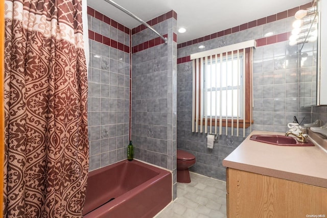 full bathroom featuring vanity, shower / bath combination, toilet, and tile walls