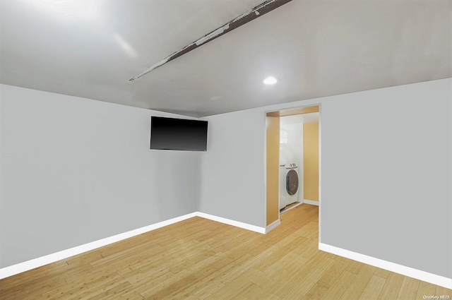 basement featuring washer / clothes dryer and light hardwood / wood-style flooring