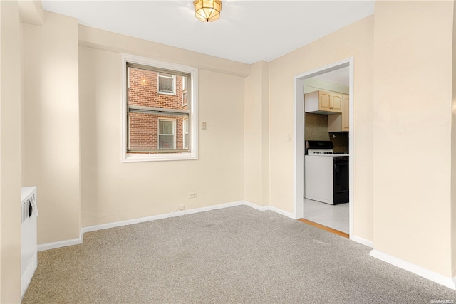 unfurnished room with light colored carpet