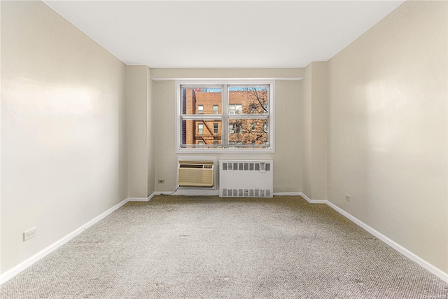 spare room with carpet flooring, radiator heating unit, and an AC wall unit