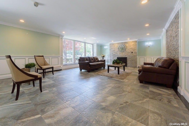 living room with crown molding and a fireplace