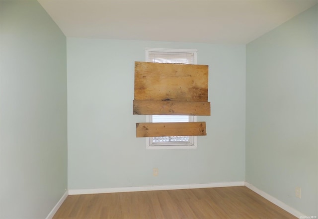 empty room with hardwood / wood-style floors and plenty of natural light