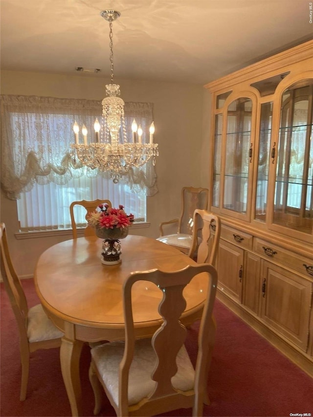 carpeted dining room with plenty of natural light and a chandelier