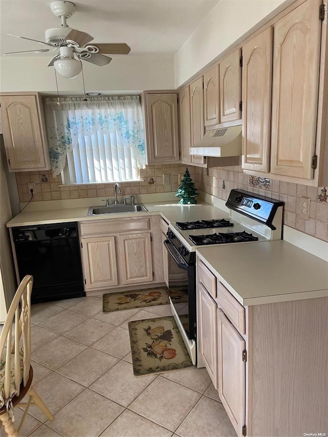 kitchen with light brown cabinets, dishwasher, white range, and sink