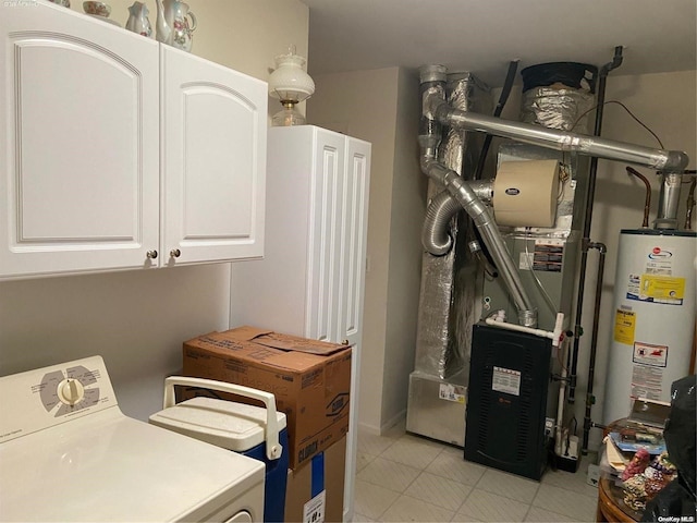 washroom featuring cabinets, washer / dryer, and water heater