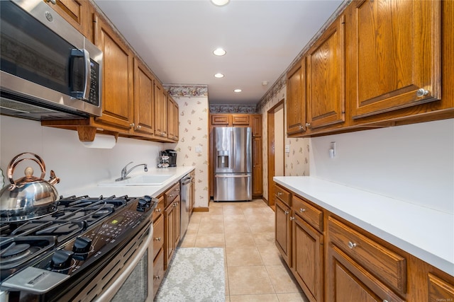 kitchen featuring light tile patterned floors, stainless steel appliances, and sink