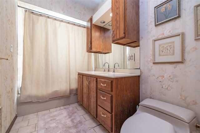 full bathroom featuring tile patterned floors, shower / bath combo with shower curtain, vanity, and toilet