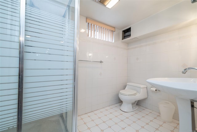 bathroom with walk in shower, tile walls, and toilet