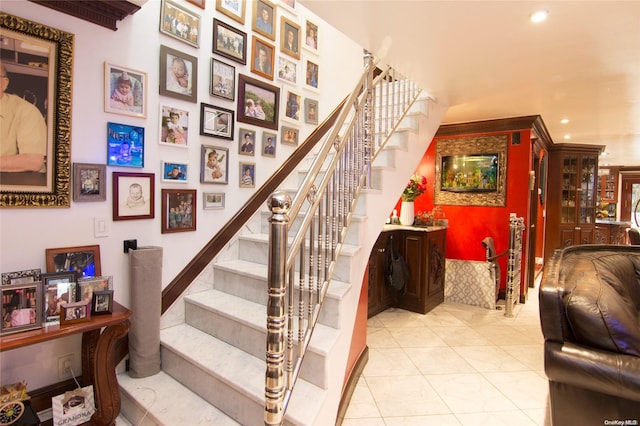 stairway with tile patterned floors