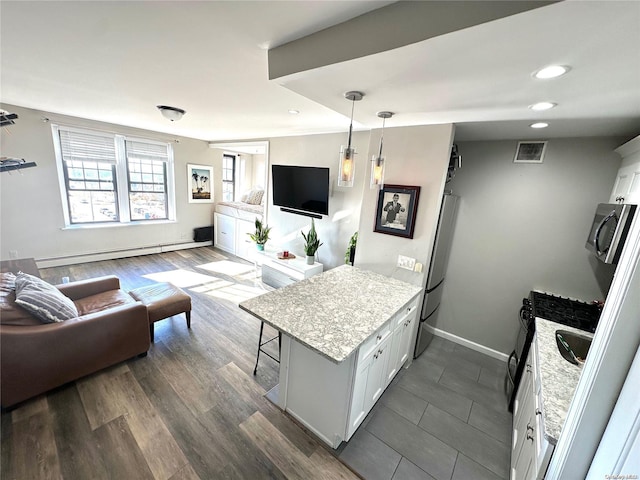 kitchen featuring white cabinets, a kitchen breakfast bar, dark wood-type flooring, and a baseboard heating unit