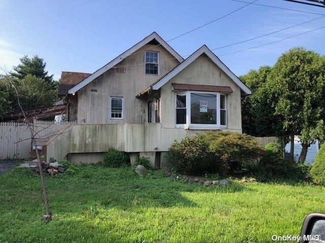 rear view of house with a yard