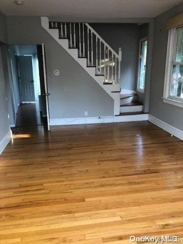 unfurnished living room with hardwood / wood-style floors