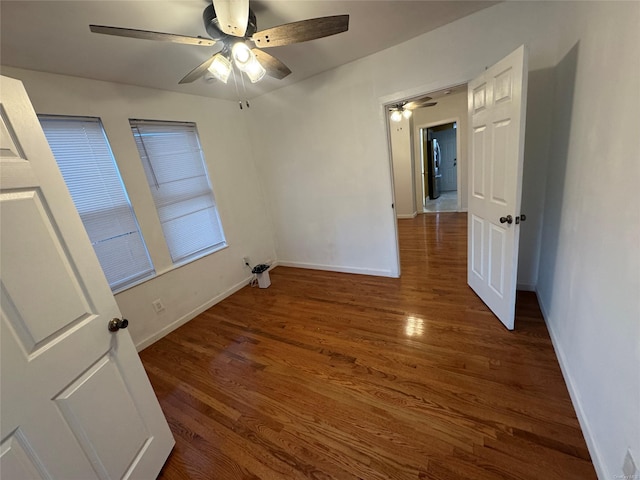 unfurnished bedroom with dark hardwood / wood-style floors and ceiling fan