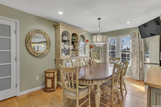 dining space with light hardwood / wood-style flooring