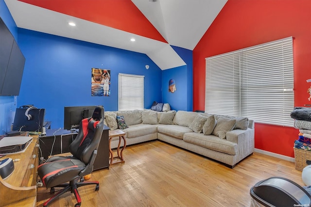 interior space with lofted ceiling and light hardwood / wood-style flooring