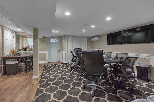 interior space with wood-type flooring and a wall mounted air conditioner