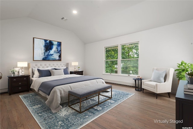 bedroom featuring hardwood / wood-style floors, baseboard heating, and lofted ceiling