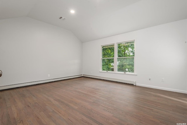 empty room featuring a baseboard heating unit, wood-type flooring, and vaulted ceiling