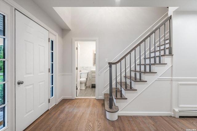 foyer entrance with a baseboard radiator and hardwood / wood-style flooring