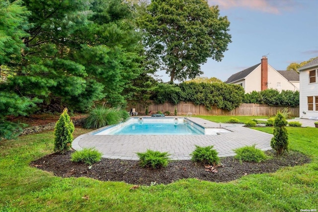 view of swimming pool featuring a patio area and a lawn