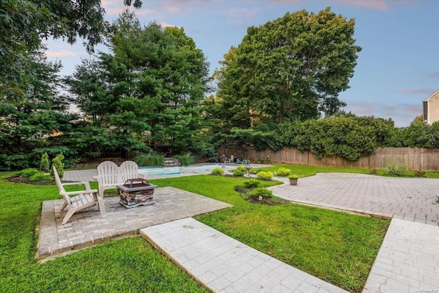 yard at dusk featuring a patio area