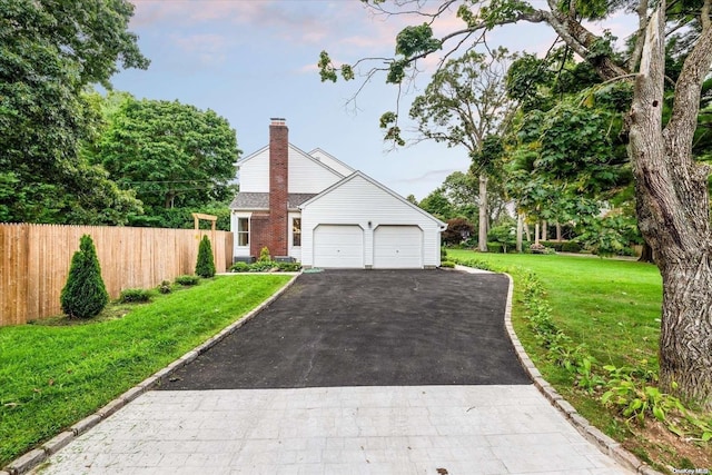 view of front of home featuring a garage and a front yard