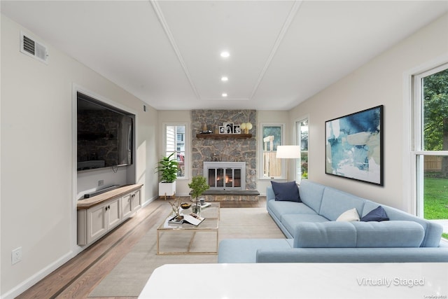 living room featuring light hardwood / wood-style floors and a fireplace