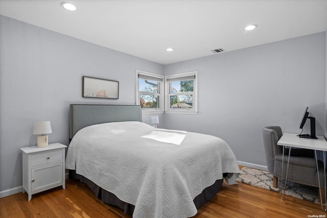 bedroom with wood-type flooring