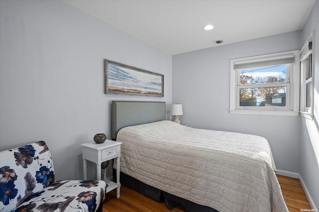 bedroom with hardwood / wood-style flooring