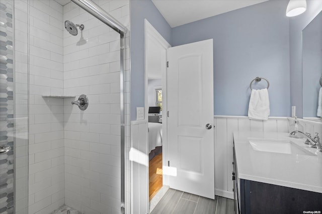 bathroom with wood-type flooring, vanity, and walk in shower