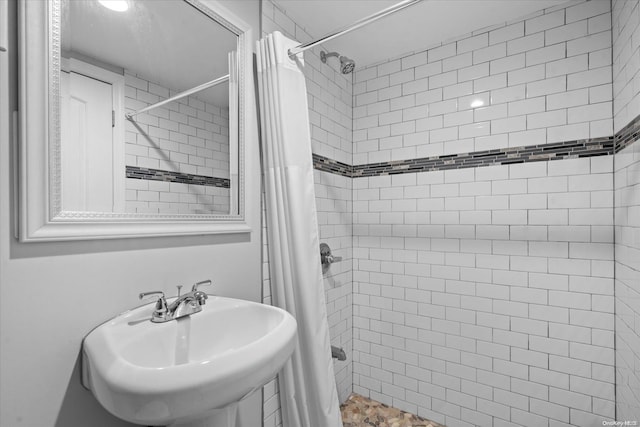 bathroom with curtained shower and sink