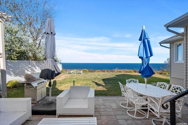 view of patio with a water view and grilling area