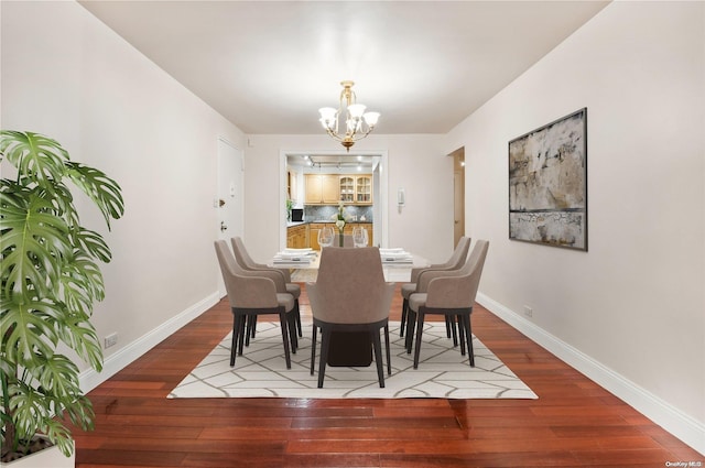 dining room featuring hardwood / wood-style floors and a notable chandelier