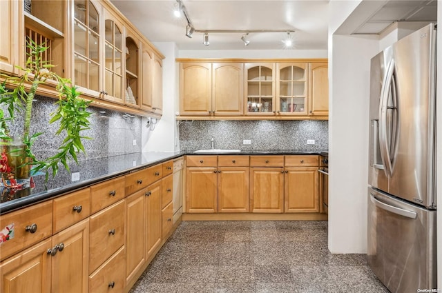 kitchen featuring backsplash, sink, stainless steel refrigerator with ice dispenser, and light brown cabinets