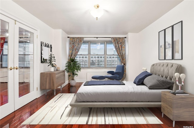 bedroom featuring french doors and dark hardwood / wood-style floors