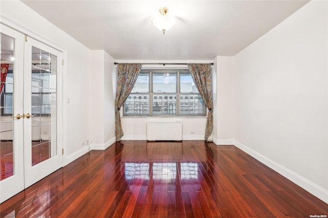 unfurnished room with dark wood-type flooring and french doors