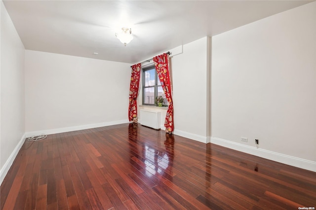 spare room featuring dark hardwood / wood-style floors