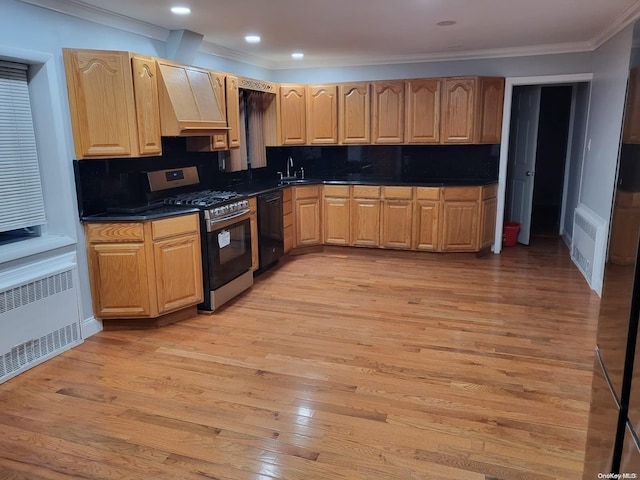 kitchen featuring decorative backsplash, light wood-type flooring, radiator, black dishwasher, and stainless steel range with gas stovetop