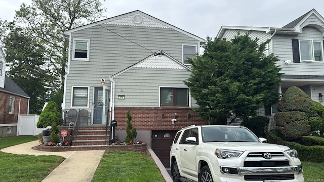 574 Lincoln St, Cedarhurst, NY 11516 - view of front facade featuring brick siding and an attached garage