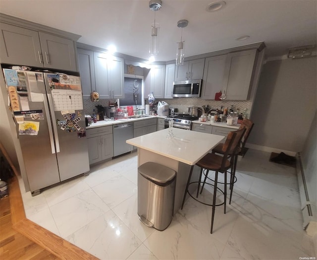 574 Lincoln St, Cedarhurst, NY 11516 - kitchen with stainless steel appliances, gray cabinets, light marble finish flooring, and light countertops