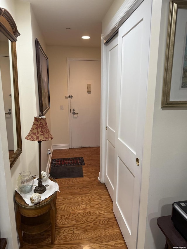 corridor with hardwood / wood-style floors