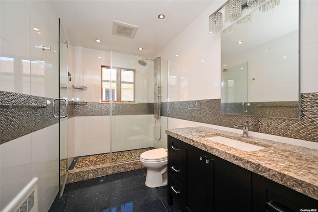 bathroom with toilet, a shower with shower door, and tile walls