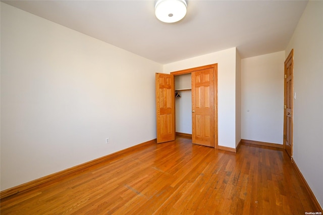 unfurnished bedroom featuring hardwood / wood-style flooring and a closet