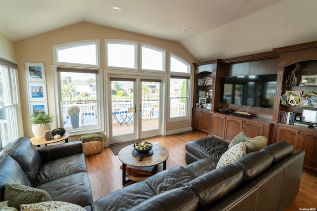 living room featuring lofted ceiling and light wood-type flooring