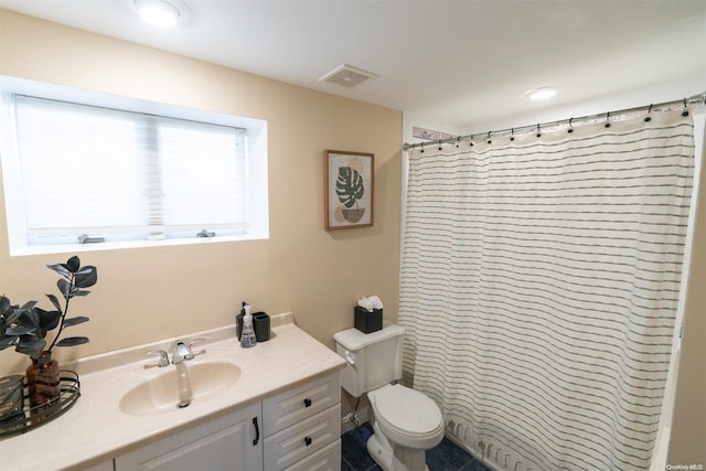 bathroom with vanity, toilet, and curtained shower