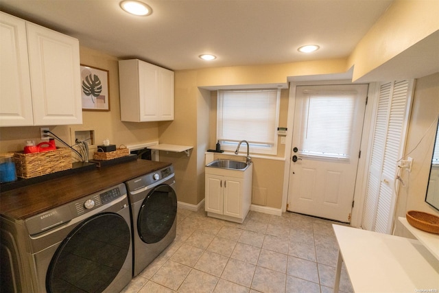 washroom featuring cabinets, light tile patterned floors, separate washer and dryer, and sink