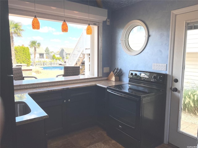 kitchen with decorative light fixtures, sink, and black range with electric cooktop