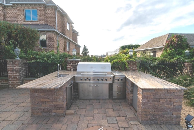 view of patio / terrace featuring sink, grilling area, and exterior kitchen