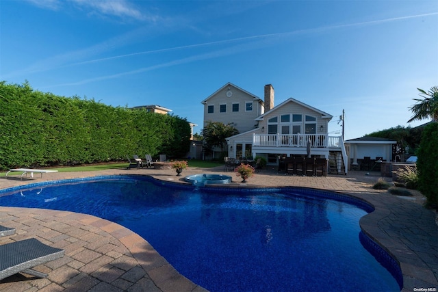 view of pool with a patio and a deck