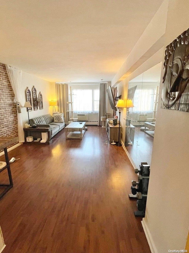 living room with plenty of natural light and dark wood-type flooring